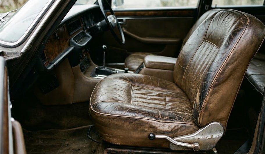 Original Mercedes-Benz W116 450SEL dashboard at dusk with only instrument lights glowing, no screens