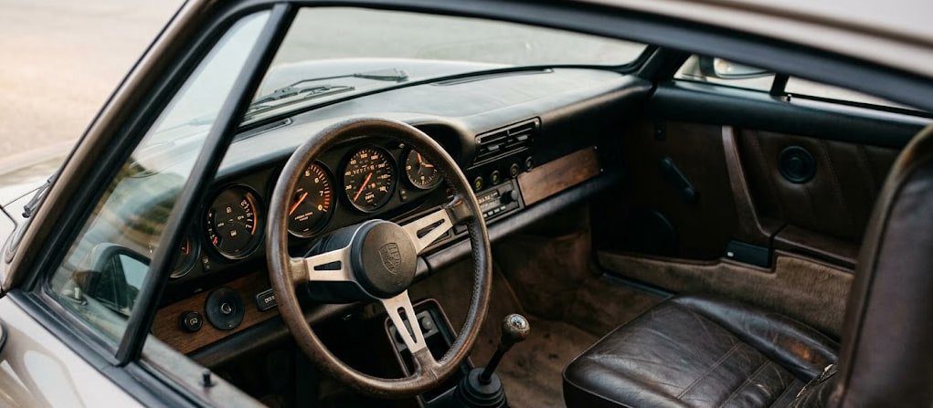 Original Porsche 911 analog dashboard with five gauges and no center screen